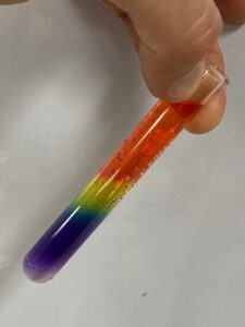 a test tube containing hydrochloric acid, universal indicator and sodium carbonate produces a pretty rainbow pattern